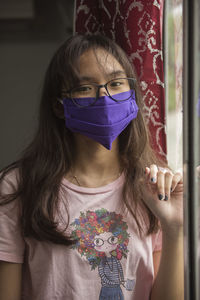 Portrait of beautiful woman standing at home