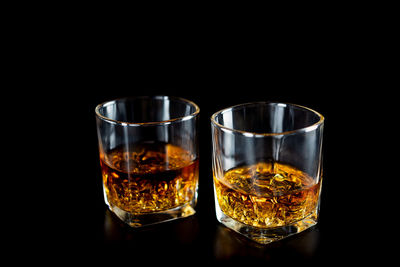 Close-up of beer glass against black background