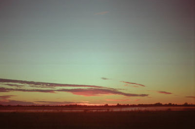 Scenic view of silhouette landscape against sky at sunset