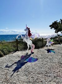 People on beach against blue sky
