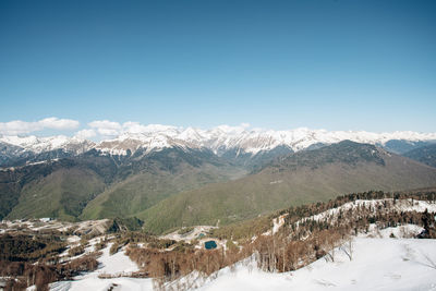 Scenic view of snowcapped mountains against clear sky