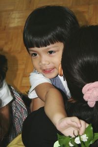 Close-up of mother carrying son at home