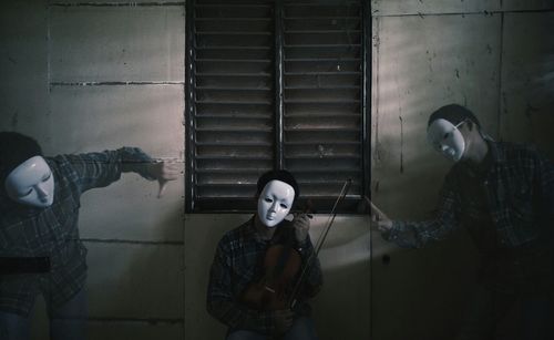 Multiple exposure of man wearing mask against building