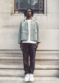 Full length of young woman standing on steps