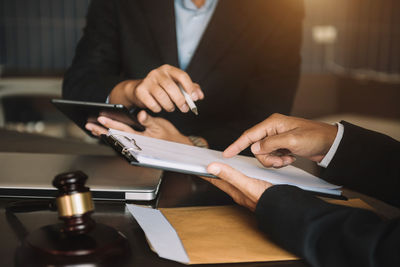 Midsection of businessman using laptop at office