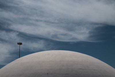 Low angle view of cross on building against sky