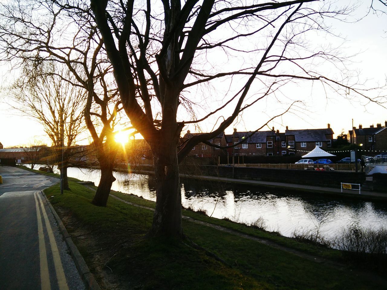 RIVER AMIDST SILHOUETTE TREES AGAINST SKY DURING SUNSET