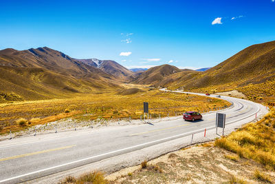 Road amidst mountains against sky