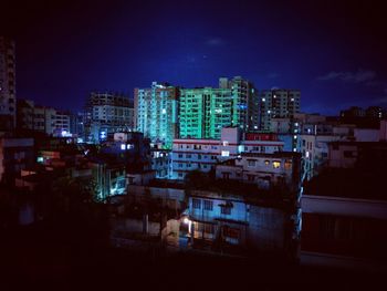 Illuminated cityscape against sky at night