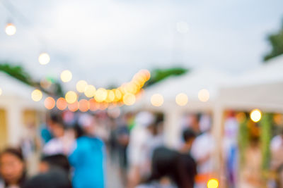 Defocused image of people at illuminated nightclub