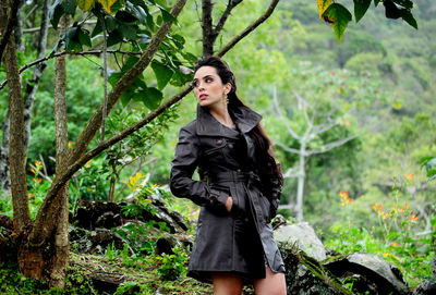 Portrait of woman standing in forest