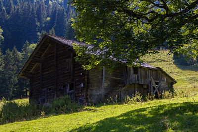 Built structure on grass against trees