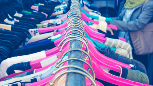 Close-up of clothes hanging on rack in store