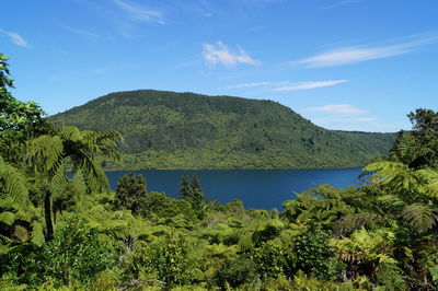 Scenic view of sea and mountains against sky