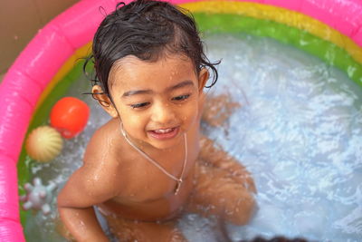 Portrait of smiling boy in swimming pool