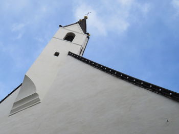 Low angle view of cross on building against sky