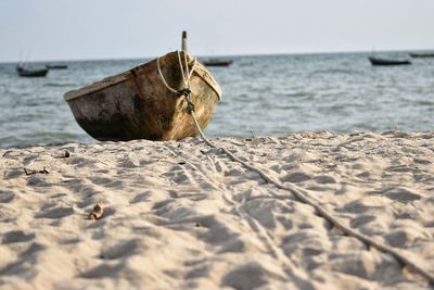 Close-up of sand on beach against sky