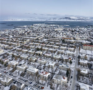 Rows of alike buildings in city district from drone