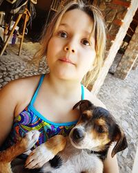 Portrait of cute girl with dog outdoors