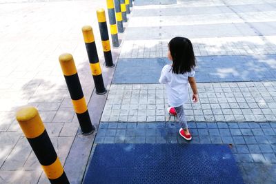 High angle view of girl standing on road