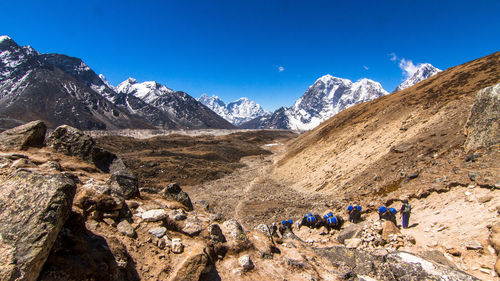 Scenic view of mountains against blue sky