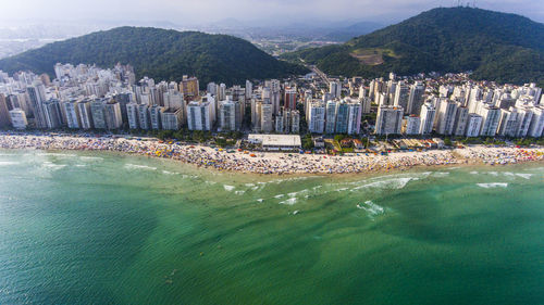 Panoramic view of city by sea against sky