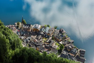 High angle view of houses by sea against sky