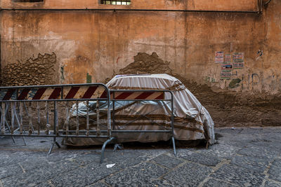 View of abandoned chair against wall