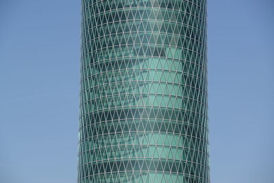 Low angle view of modern building against clear blue sky