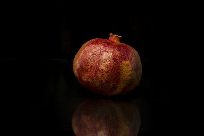 Close-up of apple against black background