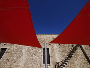 Low angle view of building against clear blue sky