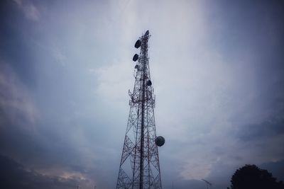 Low angle view of communications tower against sky