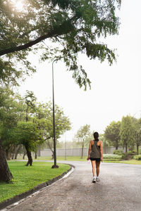 Full lenght woman walking in the park outdoor.