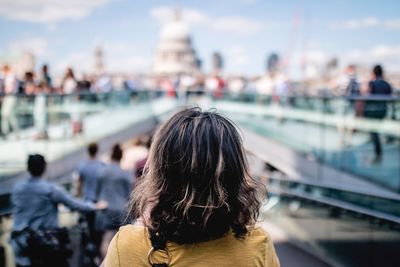 Rear view of woman on boat in city