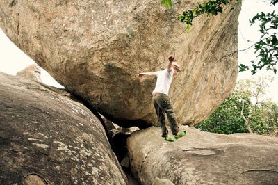 Full length of man jumping on rock