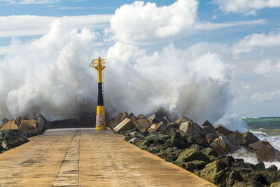 Sea waves splashing at pier