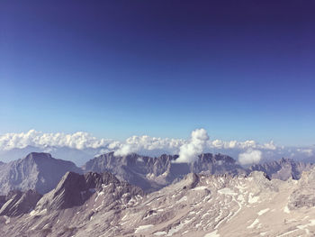 Scenic view of snowcapped mountains against clear blue sky