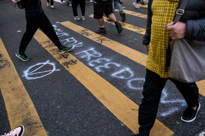 Low section of people walking on street