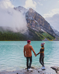Rear view of woman standing in lake