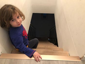 Portrait of cute girl on steps at home