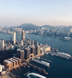 High angle view of city by sea against sky