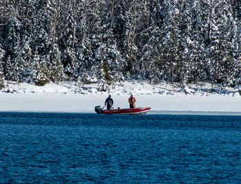 Two fisherman on boat in winter