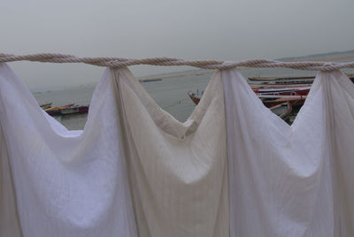 Clothes drying on clothesline against sky