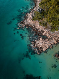 High angle view of rocks in sea