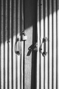 Close-up of chain hanging on metal wall