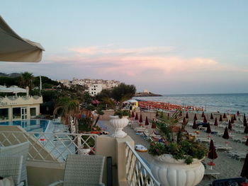 Scenic view of sea by buildings against sky