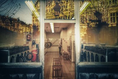 Digital composite image of building and woman in restaurant