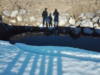 Reflection of people in swimming pool