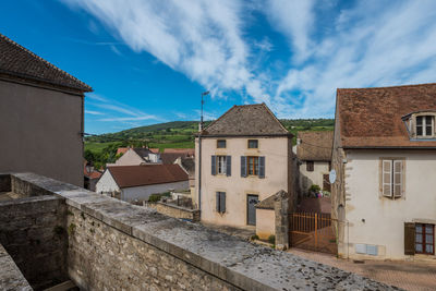 Buildings in town against sky