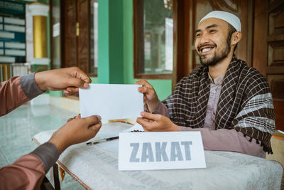 Man doing charitable donation at mosque